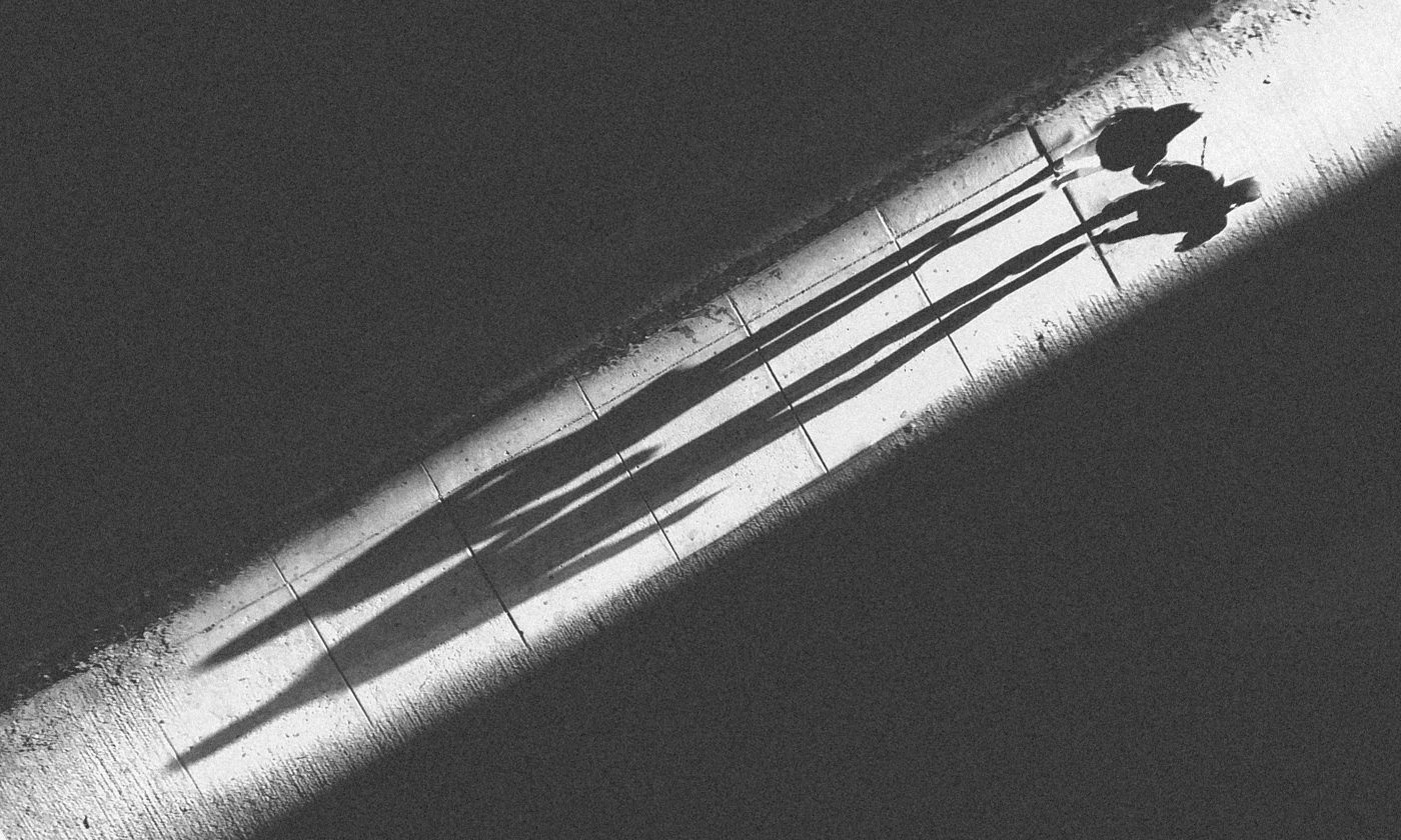 Two people walk on glowing footpath
